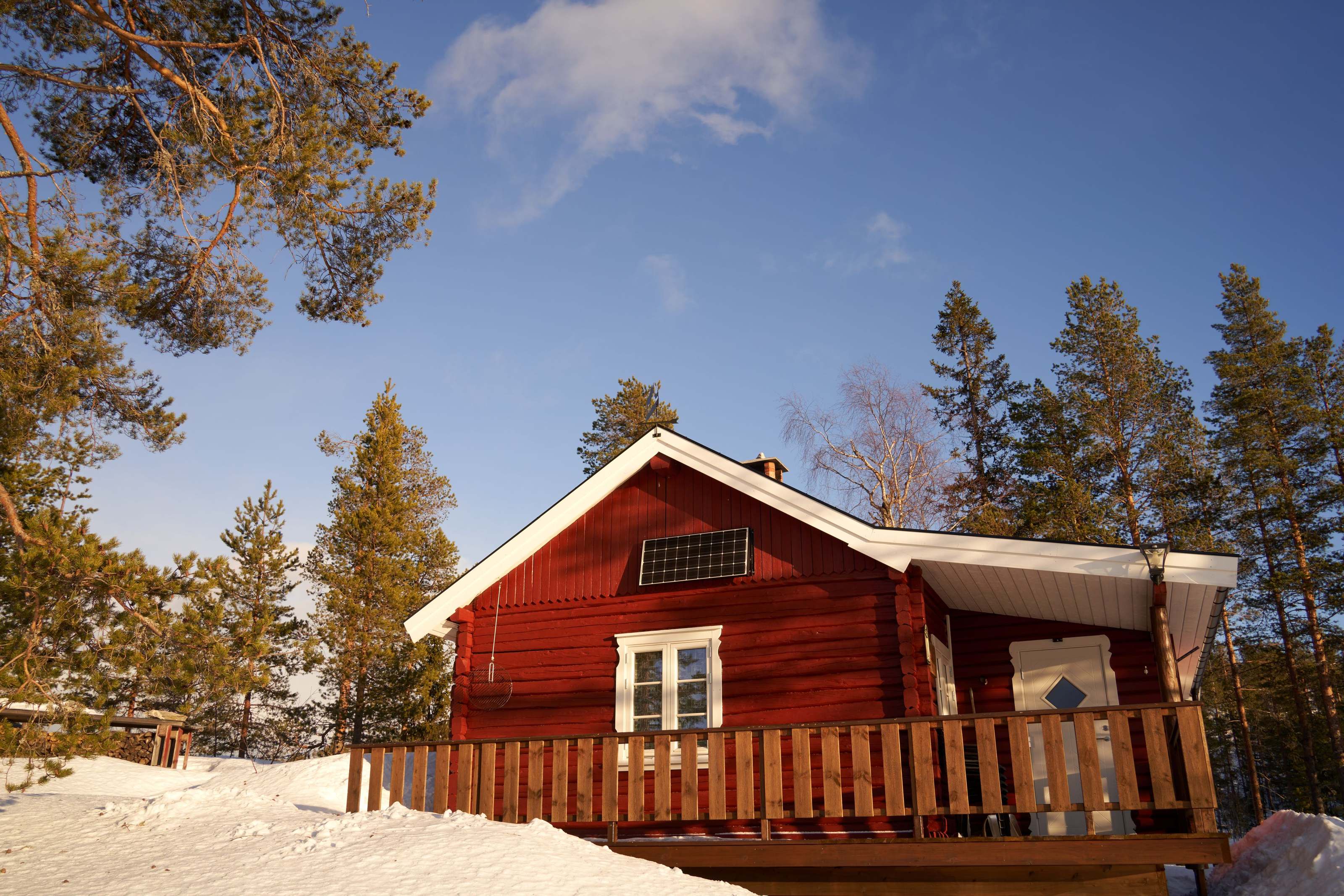 Portable power station glowing beside a lamp in a cozy off-grid cabin interior at night