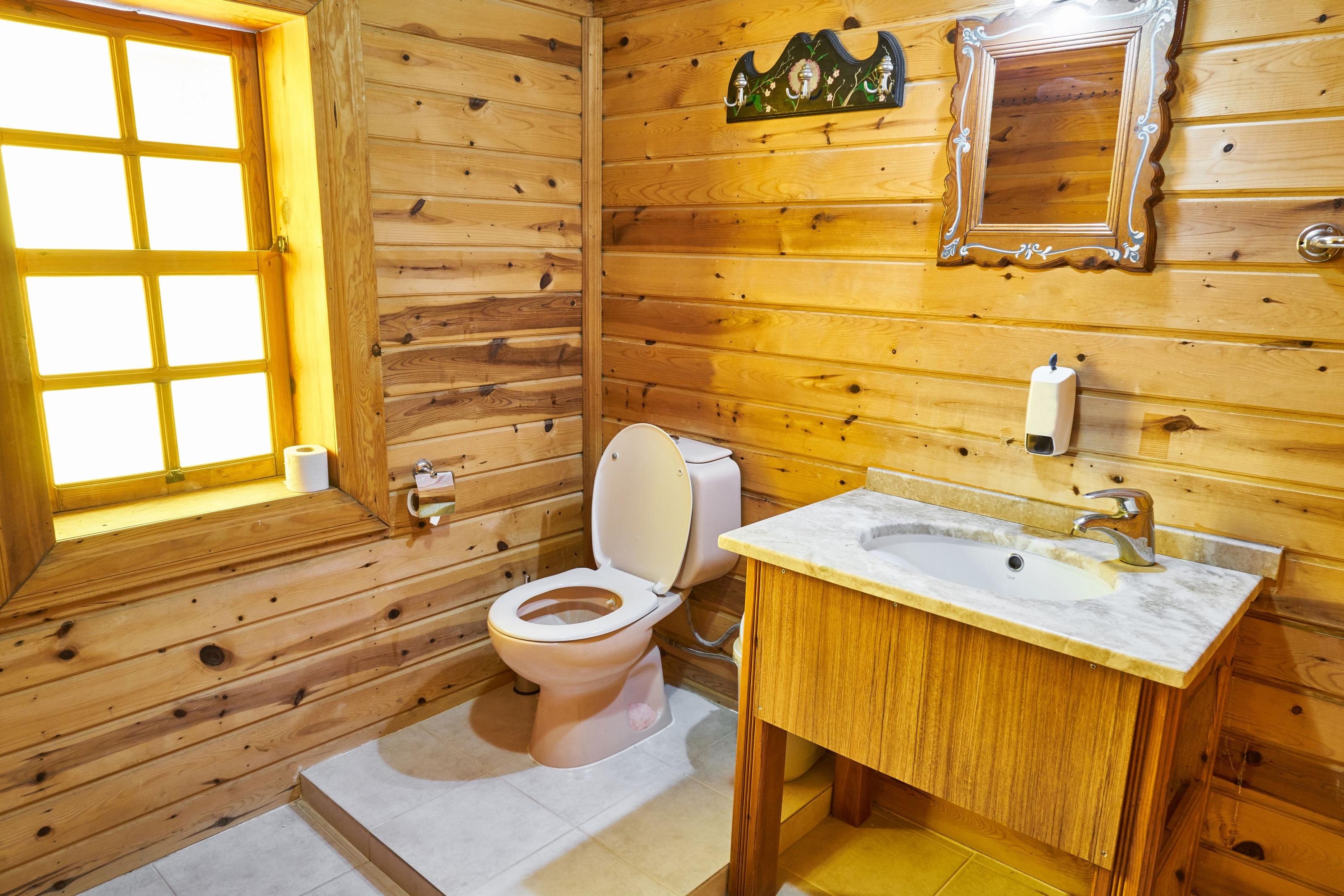 A urine-diverting composting toilet installed in a small off-grid cabin bathroom