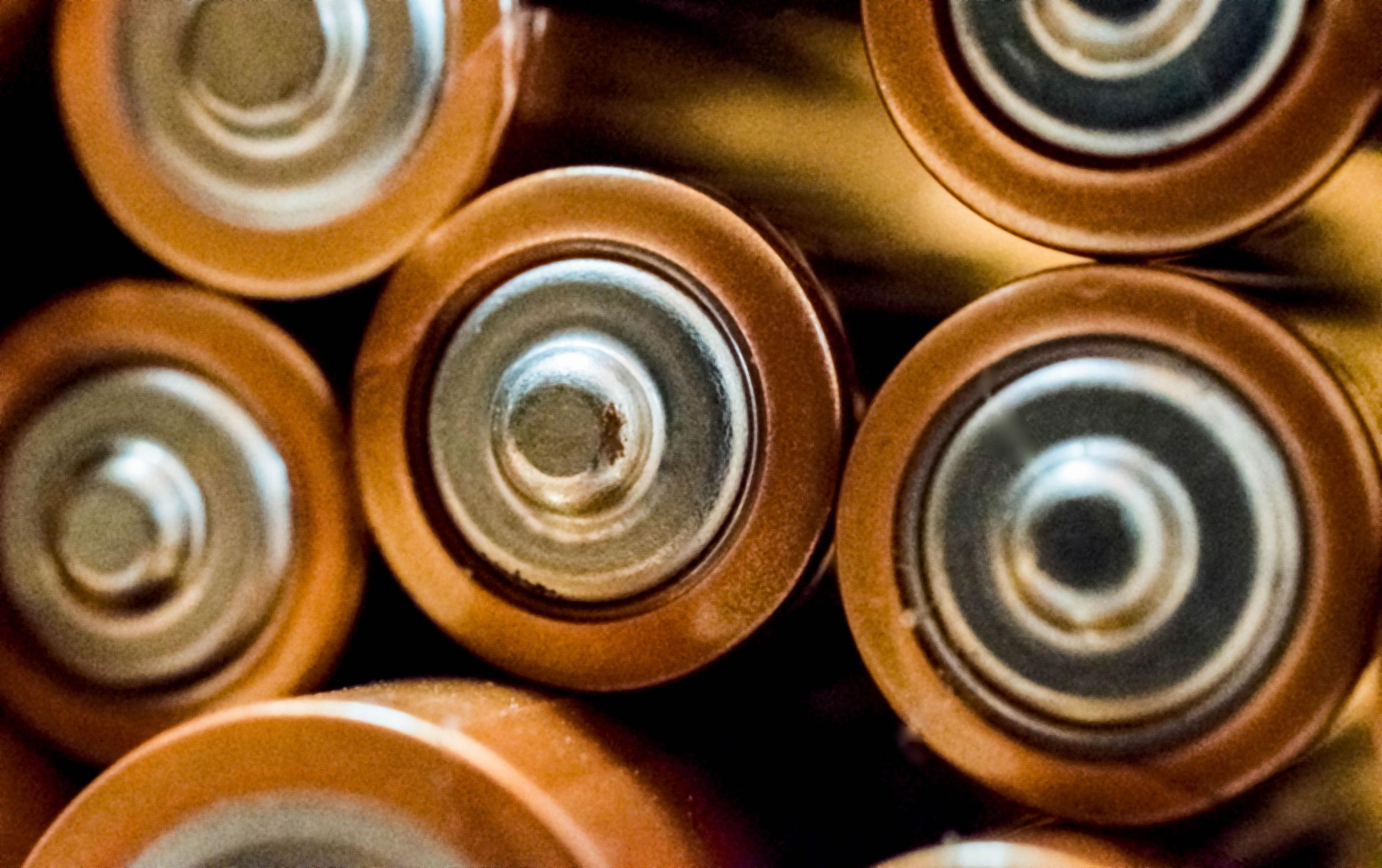Macro close-up of cylindrical lithium battery cells with metal casings and connectors, the chemistry inside every power station