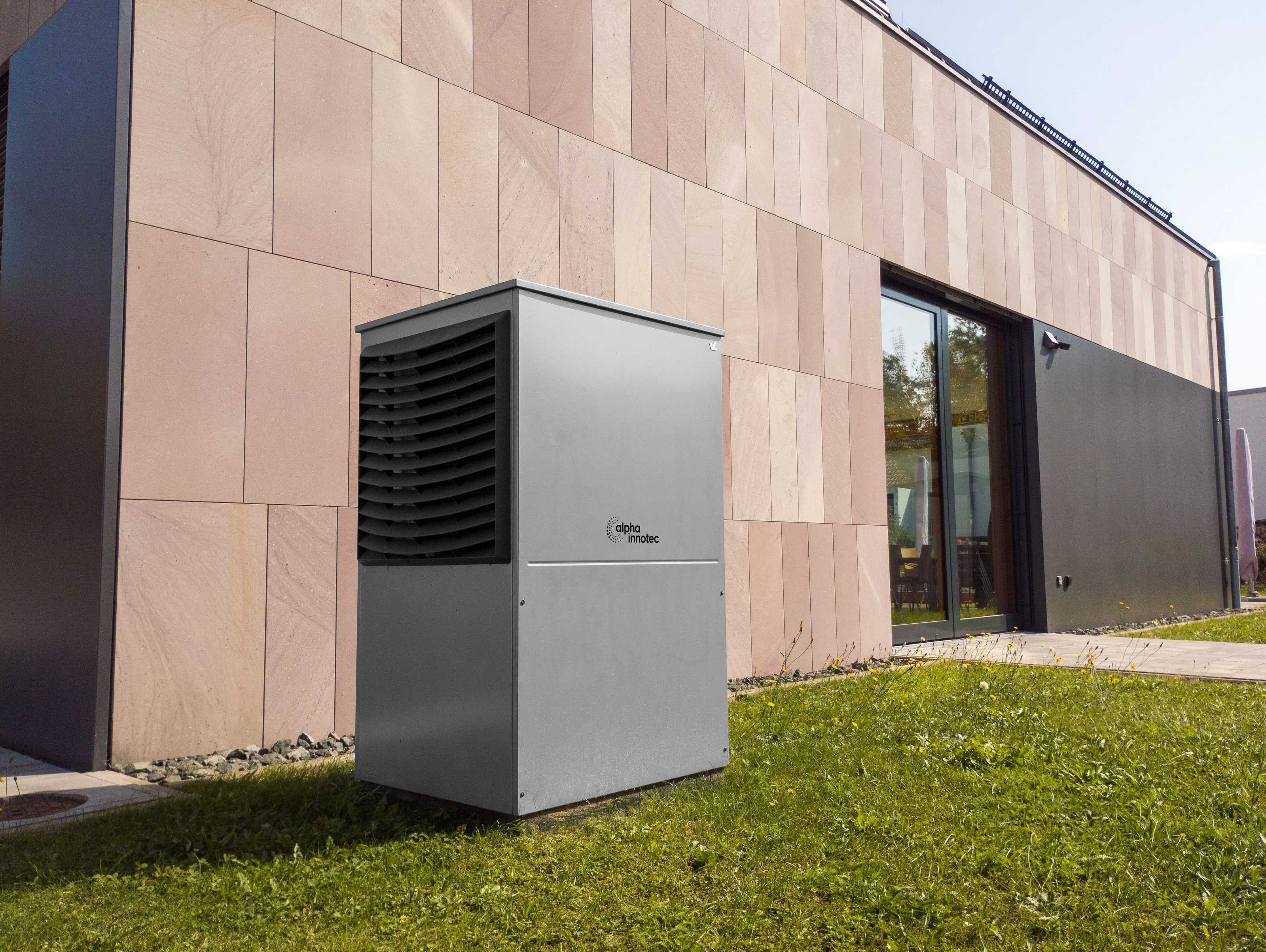 A modern mini-split heat pump wall unit mounted in a bright, well-insulated living room