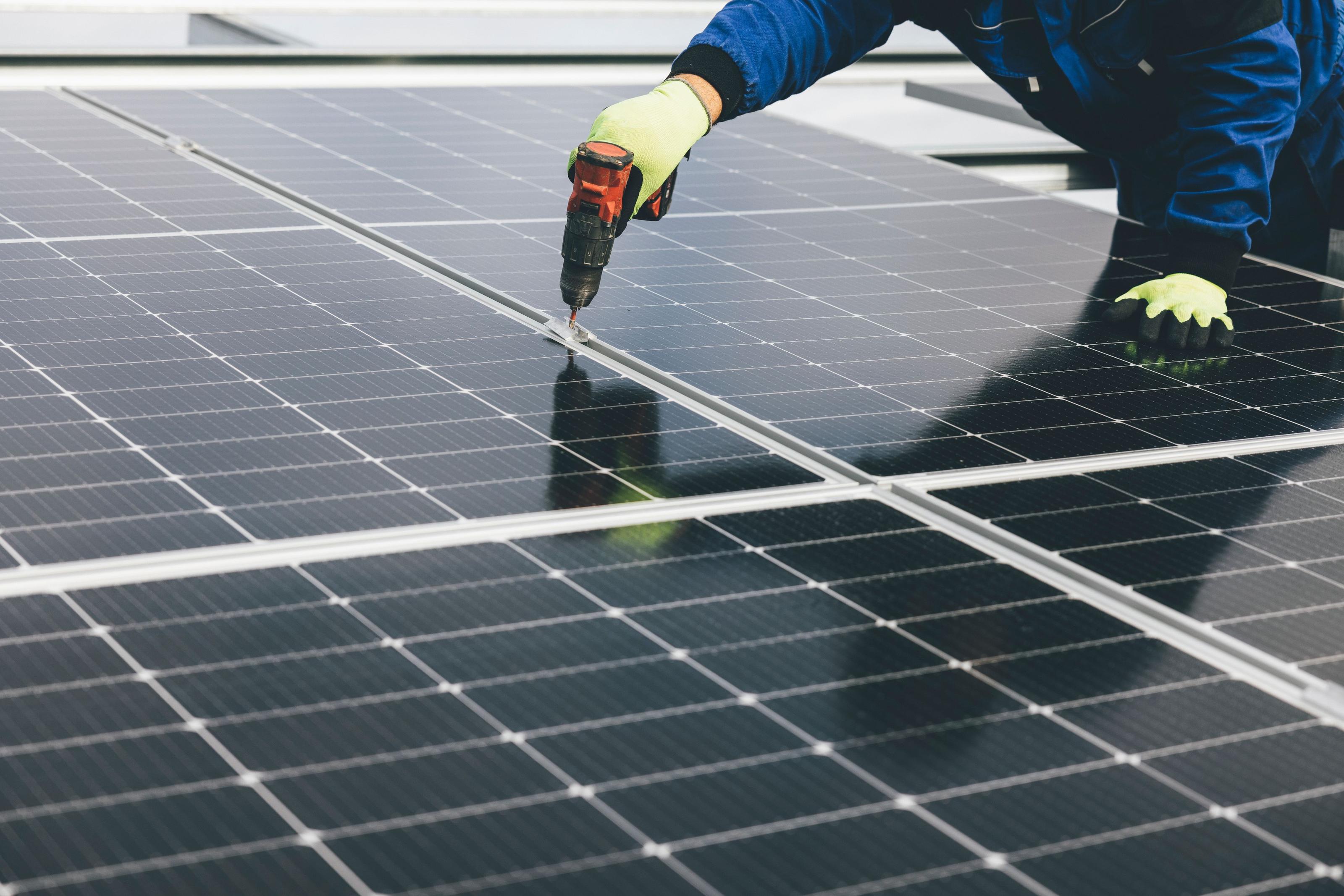 Solar installer crew working on a rooftop panel array