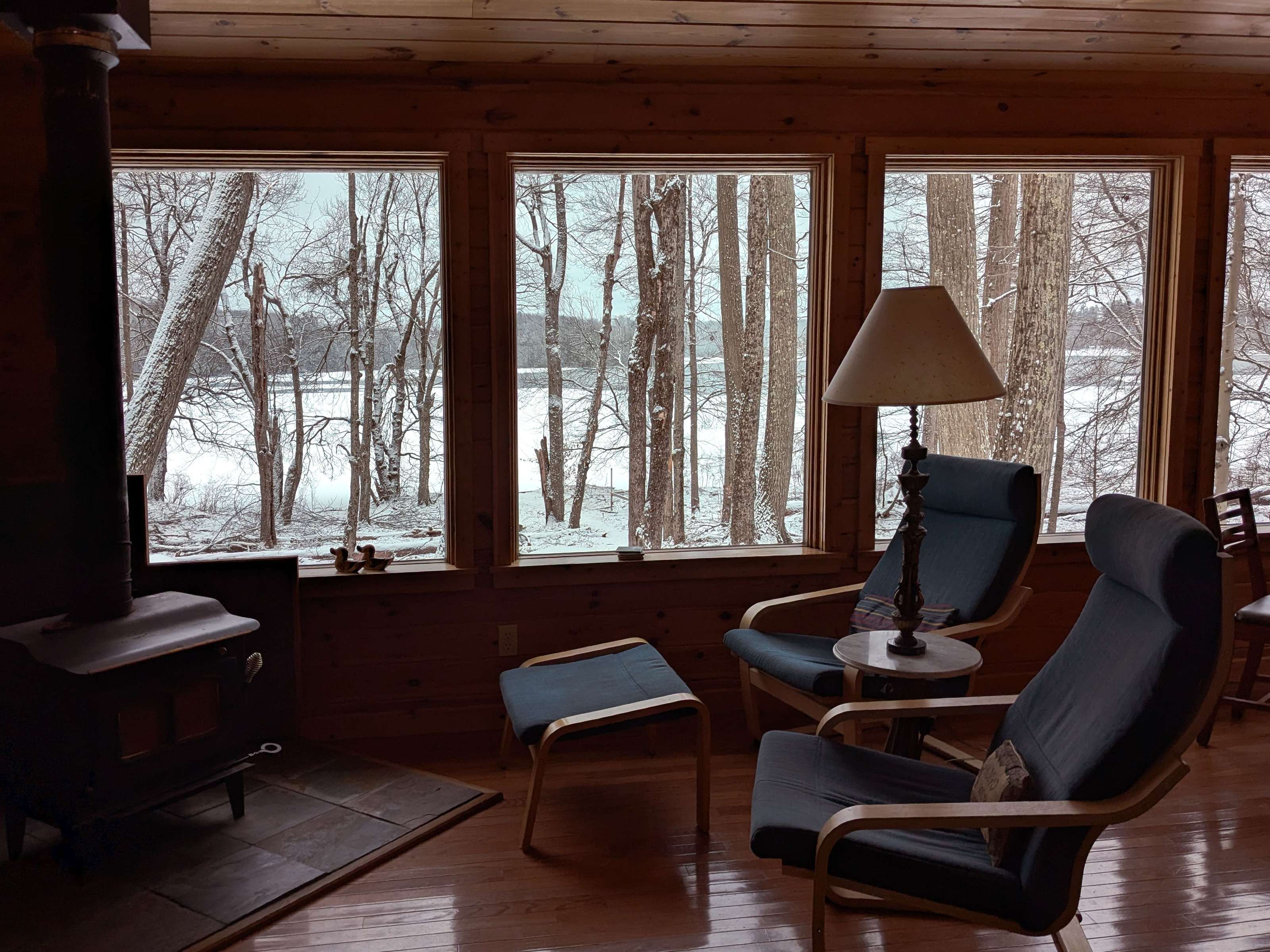Wood stove burning inside a cozy off-grid cabin interior